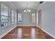 Dining room with hardwood flooring, modern chandelier, and large windows at 410 Manns Harbor Dr, Apollo Beach, FL 33572