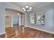 Dining room showcasing hardwood floors, modern lighting, and outdoor views at 410 Manns Harbor Dr, Apollo Beach, FL 33572