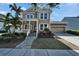 Charming two-story home featuring a manicured lawn, and two car garage at 410 Manns Harbor Dr, Apollo Beach, FL 33572