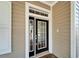 Close-up of the front door, with sidelights and detailed trim at 410 Manns Harbor Dr, Apollo Beach, FL 33572