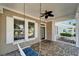 Cozy front porch featuring a swing, ceiling fan, and views of the neighborhood at 410 Manns Harbor Dr, Apollo Beach, FL 33572