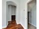 Hallway with hardwood floors, dark wood cabinet and entry to adjacent room at 410 Manns Harbor Dr, Apollo Beach, FL 33572