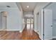 Hallway with hardwood floors, neutral paint, and arched doorways at 410 Manns Harbor Dr, Apollo Beach, FL 33572