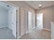 Hallway with carpet and doors leading to bedrooms and closets at 410 Manns Harbor Dr, Apollo Beach, FL 33572