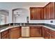 Stylish kitchen features granite counters, stainless steel appliances, and rich dark wood cabinetry at 410 Manns Harbor Dr, Apollo Beach, FL 33572