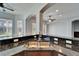 Kitchen island with a stainless steel sink and faucet, black granite countertops, and backyard view at 410 Manns Harbor Dr, Apollo Beach, FL 33572