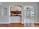 Arched doorway leads to a bright kitchen with granite countertops and stainless steel appliances at 410 Manns Harbor Dr, Apollo Beach, FL 33572