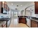 Open-concept kitchen with granite countertops and stainless steel appliances at 410 Manns Harbor Dr, Apollo Beach, FL 33572