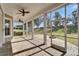 Screened in lanai with brick pavers, three ceiling fans and sliding glass doors at 410 Manns Harbor Dr, Apollo Beach, FL 33572