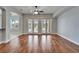Bright living room featuring hardwood floors and double doors leading to the outdoors at 410 Manns Harbor Dr, Apollo Beach, FL 33572
