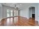Spacious living room with hardwood flooring, ceiling fan, and french doors at 410 Manns Harbor Dr, Apollo Beach, FL 33572