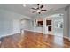 Open-concept living room with hardwood floors and view to the kitchen area at 410 Manns Harbor Dr, Apollo Beach, FL 33572