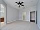 Spacious main bedroom with a ceiling fan, neutral paint, carpet flooring, and walk-in closet at 410 Manns Harbor Dr, Apollo Beach, FL 33572