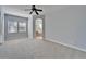 Primary bedroom with carpet flooring, an archway leading to the bathroom, and neutral walls at 410 Manns Harbor Dr, Apollo Beach, FL 33572