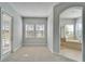 Main bedroom with neutral walls, carpet flooring, and an archway leading into the bathroom at 410 Manns Harbor Dr, Apollo Beach, FL 33572