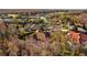 This aerial view shows this home in its private wooded community that includes a golf course and lake at 5204 Avenue La Crosse, Lutz, FL 33558