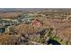 An aerial view of a community surrounded by mature trees, a golf course, and a large lake at 5204 Avenue La Crosse, Lutz, FL 33558