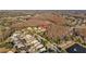 Overhead view of a neighborhood featuring well-maintained homes and winding streets near a golf course and lake at 5204 Avenue La Crosse, Lutz, FL 33558