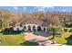 A beautiful home, aerial view showing the surrounding lush trees, and circular driveway at 5204 Avenue La Crosse, Lutz, FL 33558