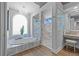 Bathroom with large soaking tub, chandelier, glass enclosed shower, and vanity at 5204 Avenue La Crosse, Lutz, FL 33558
