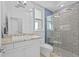 This bathroom offers a vanity with granite countertop, and a tiled walk-in shower at 5204 Avenue La Crosse, Lutz, FL 33558