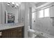 Modern bathroom features double vanity, shower with glass enclosure, and a view to the bedroom at 5204 Avenue La Crosse, Lutz, FL 33558