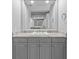 Bathroom with a large mirror and gray vanity with marble countertop at 5204 Avenue La Crosse, Lutz, FL 33558