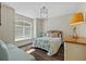 This bedroom offers a comfortable space with a bed, daybed, and plenty of natural light at 5204 Avenue La Crosse, Lutz, FL 33558