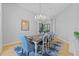 Chandelier illuminates dining room with seating for six, open to recreation space at 5204 Avenue La Crosse, Lutz, FL 33558
