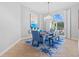 Bright dining room featuring a chandelier, large window, and blue accent rug at 5204 Avenue La Crosse, Lutz, FL 33558
