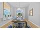 Elegant dining room with chandelier, large window, blue rug, and seating for six at 5204 Avenue La Crosse, Lutz, FL 33558