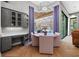 Dining room features a modern chandelier, built-in cabinets with desk area and a view to the outdoor pool at 5204 Avenue La Crosse, Lutz, FL 33558