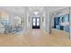 Welcoming home foyer featuring herringbone floors, elegant chandelier, and views into other living spaces at 5204 Avenue La Crosse, Lutz, FL 33558