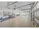 Spacious three car garage, with epoxy flooring, ceiling fan, and plenty of room for a home gym at 5204 Avenue La Crosse, Lutz, FL 33558