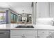 Open concept kitchen offers marble countertops and backsplash, stainless steel appliances and a view to the living room at 5204 Avenue La Crosse, Lutz, FL 33558