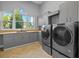 Spacious laundry room with modern appliances, cabinets, countertops, and a sink at 5204 Avenue La Crosse, Lutz, FL 33558