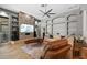 Bright and modern living room features a stone accent wall, custom built-ins and herringbone wood floors at 5204 Avenue La Crosse, Lutz, FL 33558