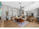 Spacious living room boasts custom built-in shelving, a unique wood coffee table and herringbone wood floors at 5204 Avenue La Crosse, Lutz, FL 33558
