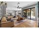 Bright living room has custom built-ins, opens to the kitchen, and provides access to the outdoor living area at 5204 Avenue La Crosse, Lutz, FL 33558