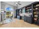 Office featuring custom built-ins, a herringbone floor, and a large window with outdoor views at 5204 Avenue La Crosse, Lutz, FL 33558
