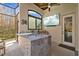 Outdoor kitchen with bar and integrated TV, perfect for poolside entertaining at 5204 Avenue La Crosse, Lutz, FL 33558