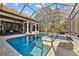 Relax in this beautiful screened-in pool and spa with an outdoor seating area, perfect for entertainment at 5204 Avenue La Crosse, Lutz, FL 33558