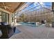 Sparkling screened-in pool and spa offer a luxurious outdoor oasis with ample patio space at 5204 Avenue La Crosse, Lutz, FL 33558