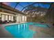 Enjoy this lovely screened-in pool and spa with an outdoor seating area, perfect for relaxation at 5204 Avenue La Crosse, Lutz, FL 33558
