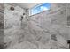 Shower with marble tile and multiple shower heads at 5204 Avenue La Crosse, Lutz, FL 33558