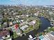 Aerial view of waterfront property and neighborhood, with a city skyline in the distance at 547 Suwanee Cir, Tampa, FL 33606