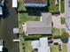 Aerial view of home featuring a backyard oasis with lush landscaping, and canal access at 547 Suwanee Cir, Tampa, FL 33606