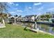 Serene backyard setting with lush lawn and waterfront access at 547 Suwanee Cir, Tampa, FL 33606