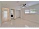 Bright room features shuttered windows, ceiling fan, and adjacent door with a partial bathroom view at 547 Suwanee Cir, Tampa, FL 33606