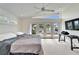 Bright bedroom featuring a ceiling fan, white carpet, and glass doors to the water at 547 Suwanee Cir, Tampa, FL 33606